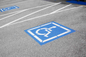 ADA compliant parking space with handicap parking sign painted on concrete
