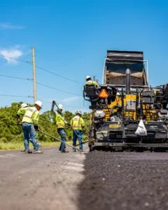 employees paving a road