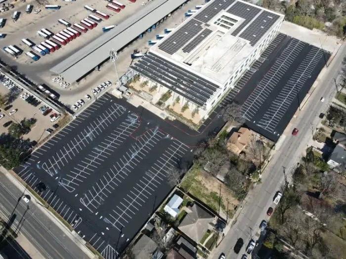 A large parking lot received new asphalt, stripes, and directional arrows.