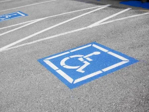 ADA compliant parking space with handicap parking sign painted on concrete