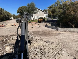 RDC tearing up a parking lot with an excavator.