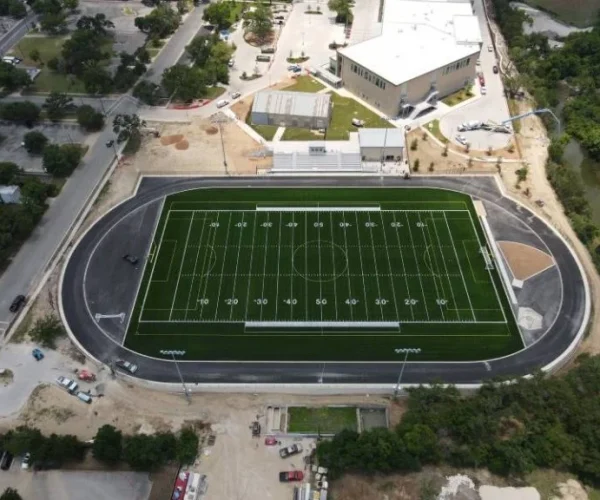 A newly paved track around a football field.