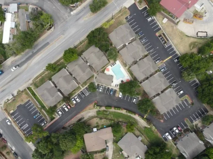 An apartment complex gets a facelift with a new parking lot and striping.